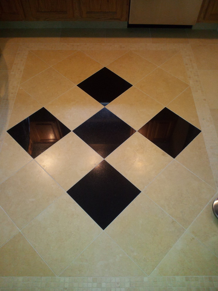 Mid-sized elegant porcelain tile kitchen photo in New York with raised-panel cabinets and medium tone wood cabinets