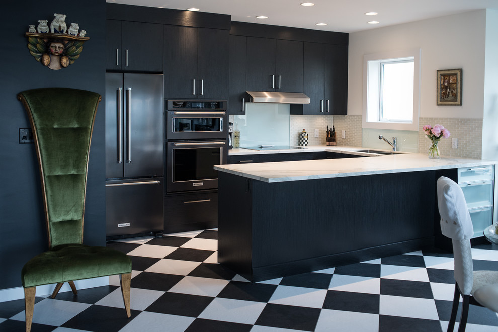 This is an example of a small contemporary u-shaped kitchen/diner in Vancouver with a submerged sink, flat-panel cabinets, black cabinets, glass tiled splashback, black appliances, vinyl flooring and a breakfast bar.