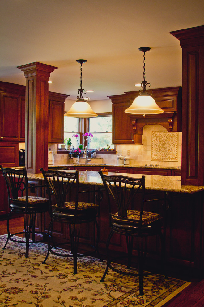 Eat-in kitchen - mid-sized traditional l-shaped dark wood floor eat-in kitchen idea in Cincinnati with an undermount sink, raised-panel cabinets, stone tile backsplash, stainless steel appliances, an island, medium tone wood cabinets, marble countertops and brown backsplash