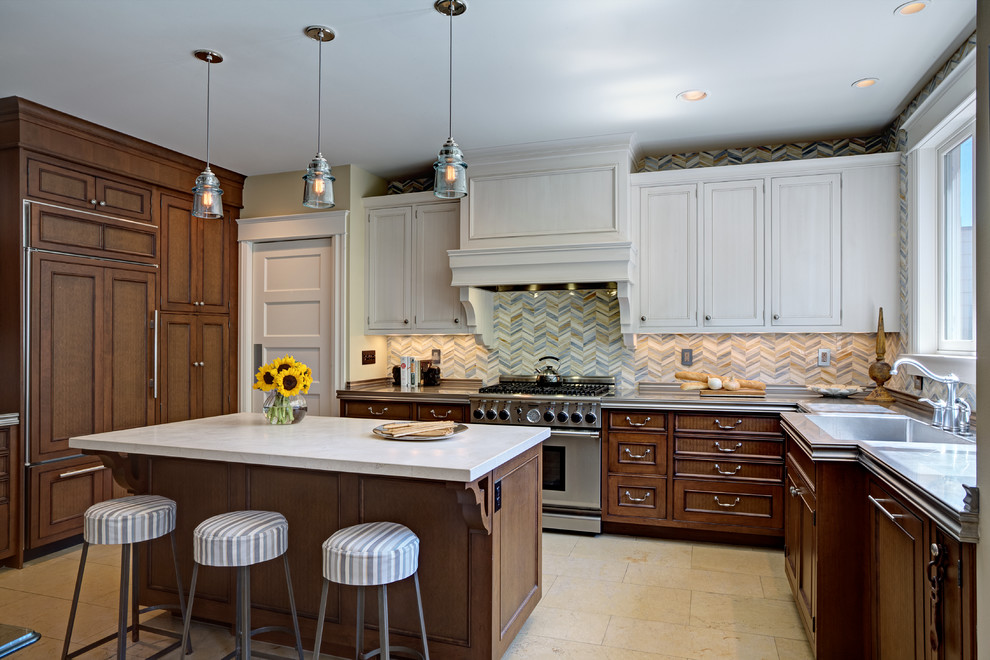 Example of a large transitional u-shaped limestone floor eat-in kitchen design in San Francisco with an integrated sink, raised-panel cabinets, medium tone wood cabinets, zinc countertops, multicolored backsplash, mosaic tile backsplash, stainless steel appliances and an island