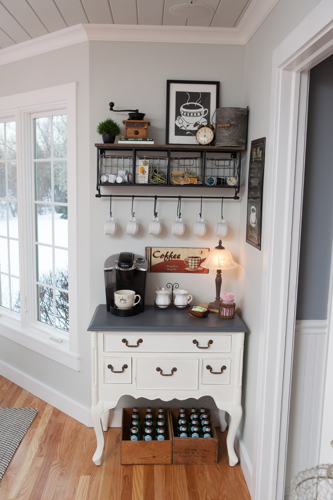 Example of a mid-sized transitional u-shaped medium tone wood floor eat-in kitchen design in Chicago with a farmhouse sink, recessed-panel cabinets, white cabinets, multicolored backsplash, subway tile backsplash, stainless steel appliances and an island