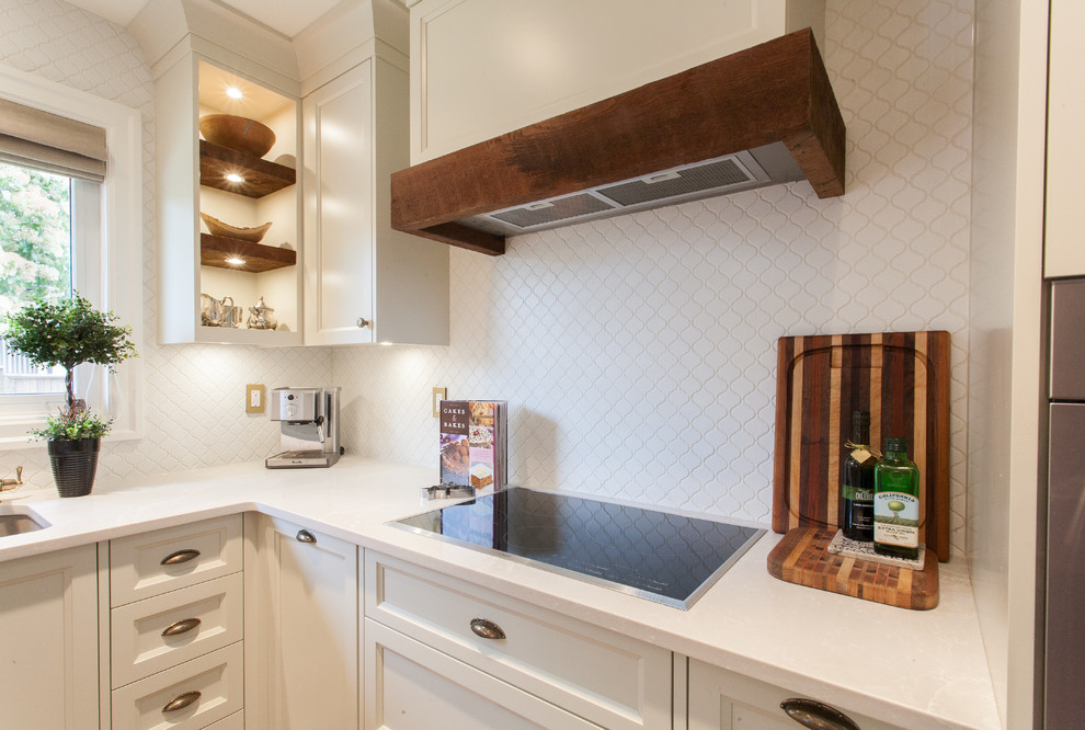 Example of a mid-sized cottage chic u-shaped medium tone wood floor open concept kitchen design in Vancouver with an undermount sink, shaker cabinets, white cabinets, quartz countertops, white backsplash, mosaic tile backsplash, paneled appliances and no island