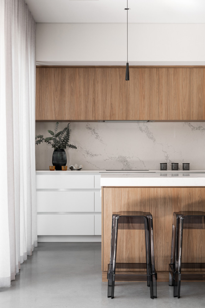 Medium sized midcentury galley open plan kitchen in Perth with flat-panel cabinets, medium wood cabinets, engineered stone countertops, marble splashback, concrete flooring and an island.