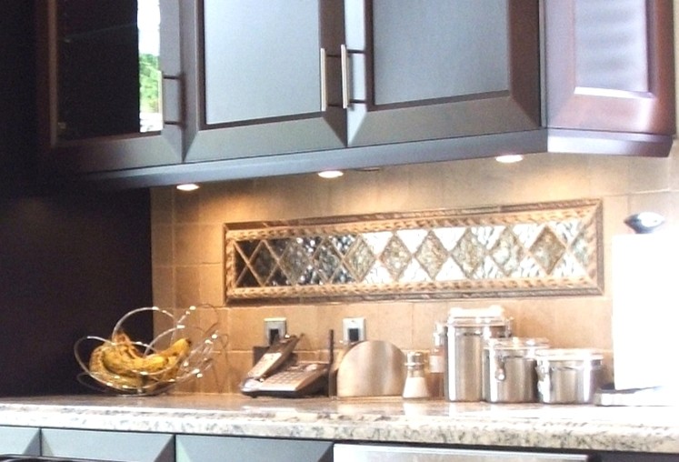 Mediterranean kitchen in San Diego with recessed-panel cabinets, granite worktops, beige splashback, stone tiled splashback and stainless steel appliances.
