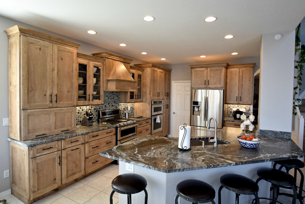 Example of a large classic u-shaped open concept kitchen design in Denver with an undermount sink, beaded inset cabinets, medium tone wood cabinets, multicolored backsplash, mosaic tile backsplash, stainless steel appliances and a peninsula