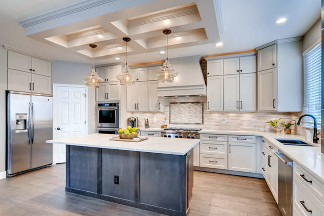 Mid-sized trendy u-shaped light wood floor and beige floor eat-in kitchen photo in Denver with a double-bowl sink, beige backsplash, stainless steel appliances, an island, beige cabinets, solid surface countertops, porcelain backsplash and recessed-panel cabinets