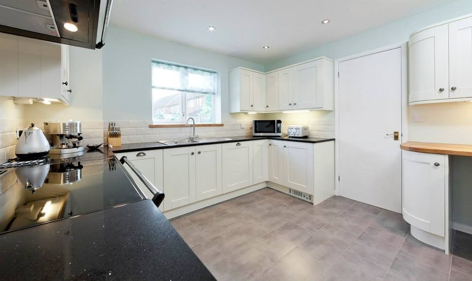 This is an example of a contemporary grey and cream kitchen in Essex.