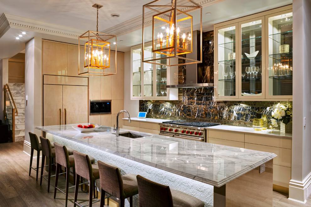 Mid-sized transitional l-shaped medium tone wood floor eat-in kitchen photo in Vancouver with an undermount sink, flat-panel cabinets, light wood cabinets, marble countertops, brown backsplash, stone slab backsplash, paneled appliances and an island