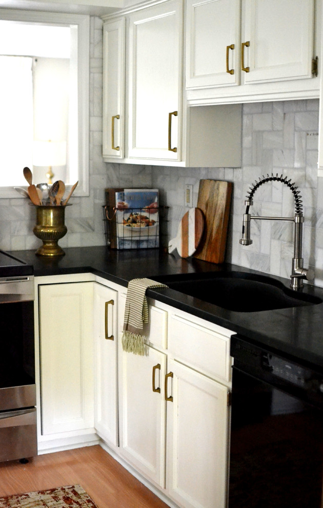 Inspiration for a mid-sized eclectic u-shaped enclosed kitchen remodel in Houston with raised-panel cabinets, white cabinets, soapstone countertops, white backsplash, marble backsplash, stainless steel appliances and an island