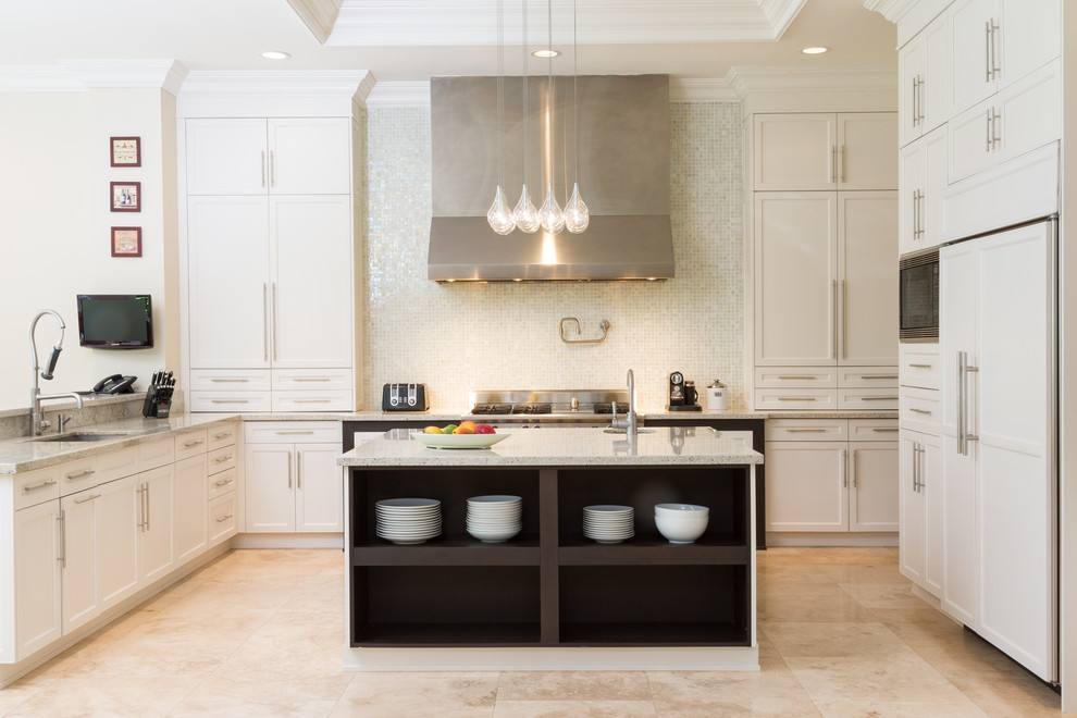 Expansive traditional l-shaped kitchen pantry in Miami with a submerged sink, shaker cabinets, white cabinets, granite worktops, metallic splashback, mosaic tiled splashback, integrated appliances, limestone flooring, an island and beige floors.