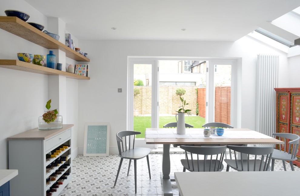 Kitchen/dining room combo - traditional ceramic tile kitchen/dining room combo idea in London