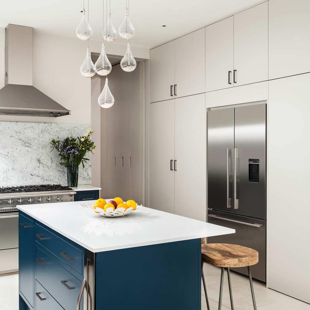 Design ideas for a medium sized contemporary l-shaped kitchen in London with flat-panel cabinets, blue cabinets, an island and beige floors.