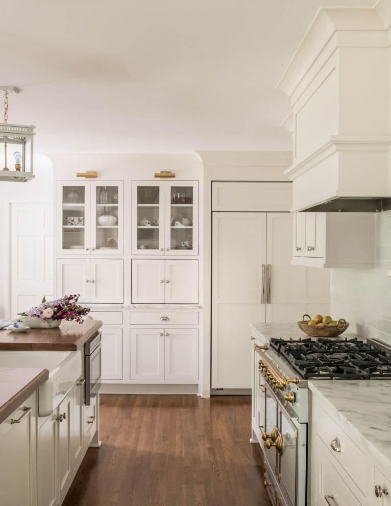 Kitchen photo in Charlotte with white cabinets and an island