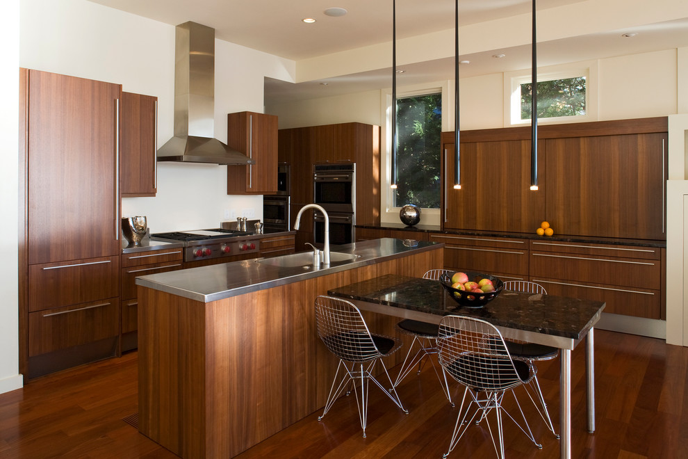 Photo of a contemporary open plan kitchen in Baltimore with flat-panel cabinets, dark wood cabinets and stainless steel worktops.