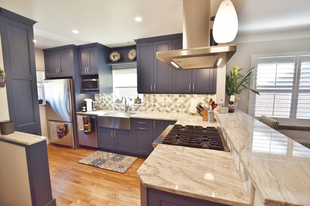 Small transitional l-shaped medium tone wood floor eat-in kitchen photo in Denver with a farmhouse sink, recessed-panel cabinets, blue cabinets, gray backsplash, stainless steel appliances and no island