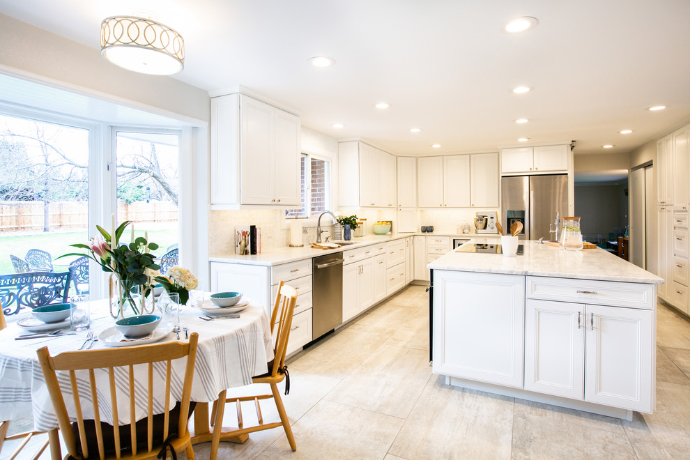 Inspiration for a huge timeless l-shaped porcelain tile and gray floor eat-in kitchen remodel in Denver with an undermount sink, recessed-panel cabinets, white cabinets, granite countertops, white backsplash, marble backsplash, stainless steel appliances, an island and white countertops