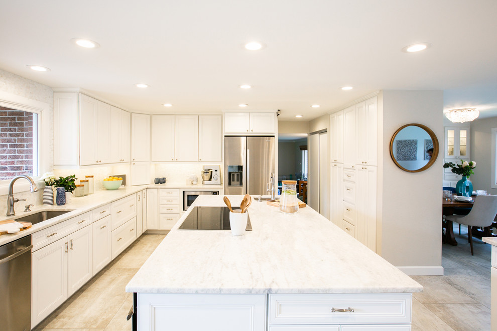 Huge elegant l-shaped porcelain tile and gray floor eat-in kitchen photo in Denver with an undermount sink, recessed-panel cabinets, white cabinets, granite countertops, white backsplash, marble backsplash, stainless steel appliances, an island and white countertops