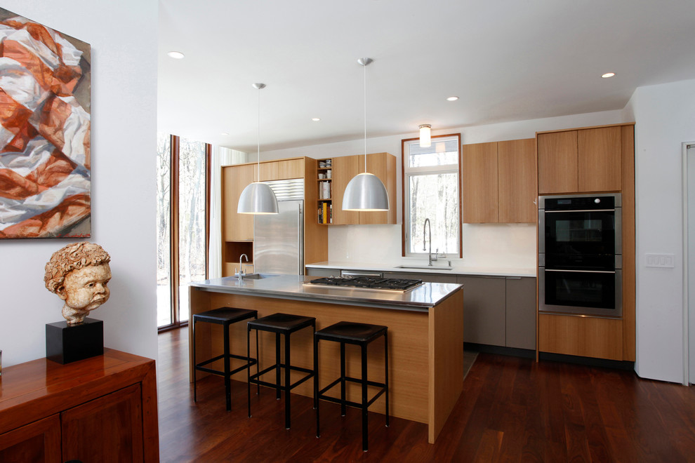 Example of a mid-sized trendy single-wall dark wood floor and red floor enclosed kitchen design in New York with an undermount sink, flat-panel cabinets, medium tone wood cabinets, quartz countertops, stainless steel appliances, an island and gray countertops