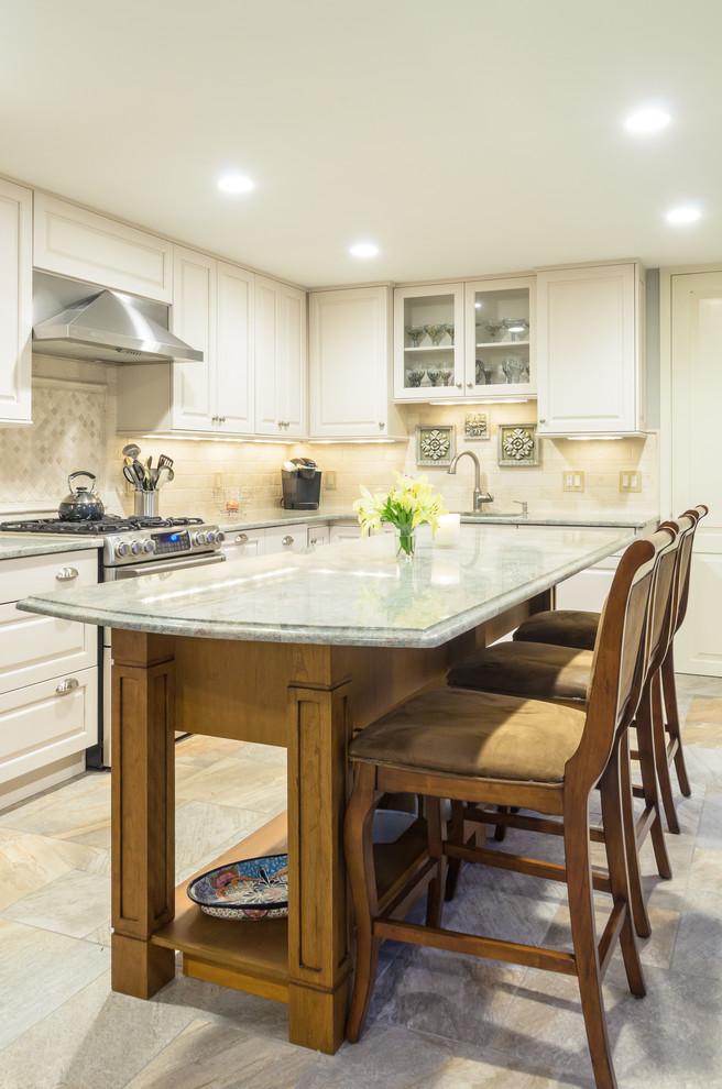 Elegant l-shaped eat-in kitchen photo in Boston with an undermount sink, raised-panel cabinets, beige cabinets, granite countertops, ceramic backsplash, stainless steel appliances and an island