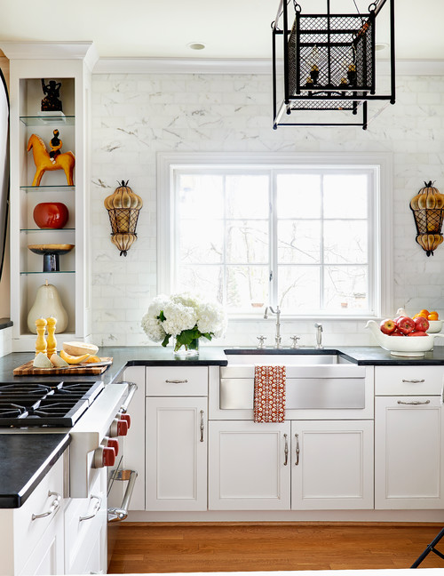 Beaded Inset White Cabinets with Black Countertops and a Medium-Toned Wood Floor