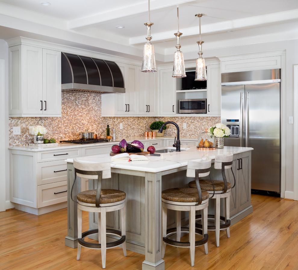 Large rustic l-shaped enclosed kitchen in DC Metro with a submerged sink, shaker cabinets, multi-coloured splashback, stainless steel appliances, light hardwood flooring, an island, white cabinets, engineered stone countertops and mosaic tiled splashback.
