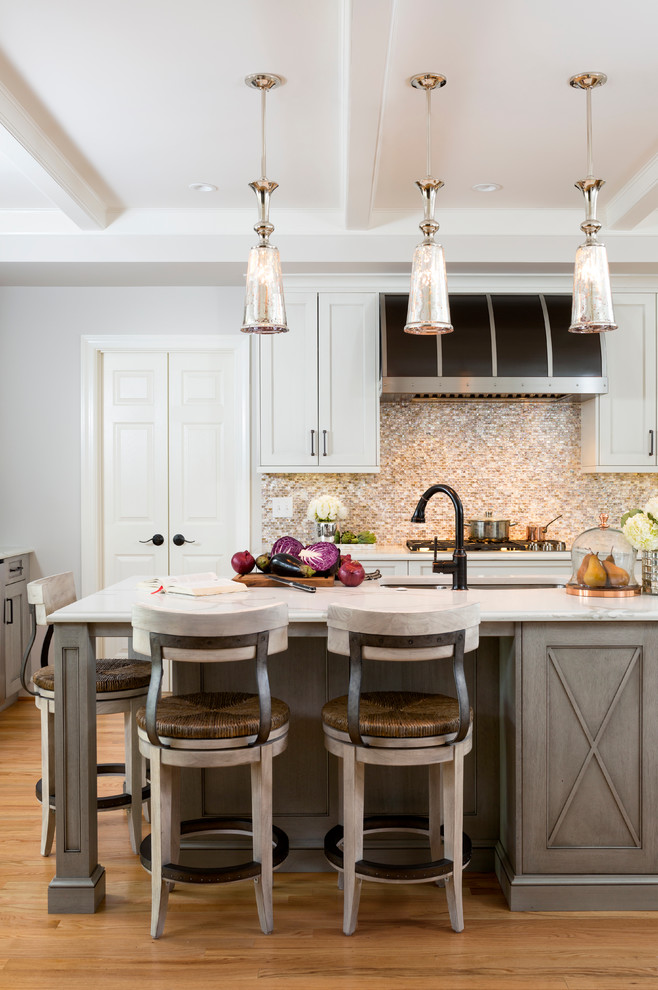 Example of a large mountain style l-shaped light wood floor enclosed kitchen design in DC Metro with an undermount sink, shaker cabinets, white cabinets, quartz countertops, multicolored backsplash, mosaic tile backsplash, stainless steel appliances and an island