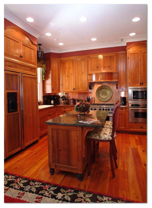 Example of a mid-sized classic l-shaped dark wood floor eat-in kitchen design in Atlanta with a drop-in sink, flat-panel cabinets, medium tone wood cabinets, granite countertops, metallic backsplash, metal backsplash, stainless steel appliances and an island