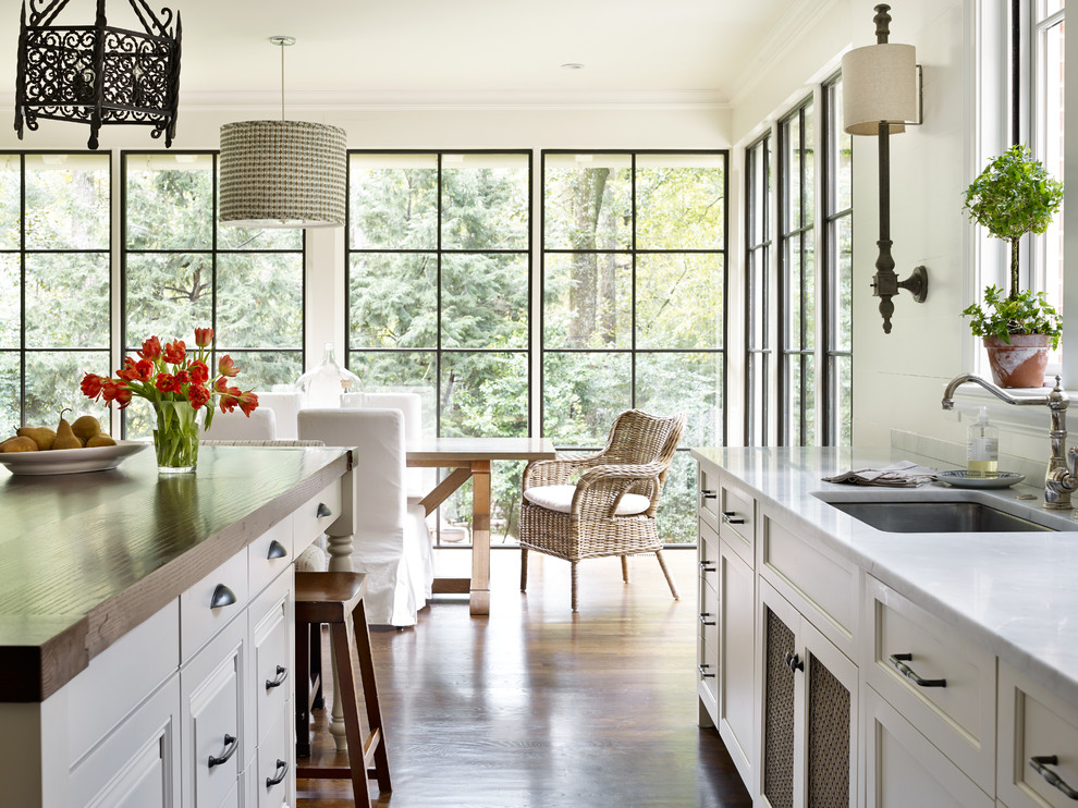 Inspiration for a timeless medium tone wood floor eat-in kitchen remodel in Atlanta with an undermount sink, recessed-panel cabinets, white cabinets and an island