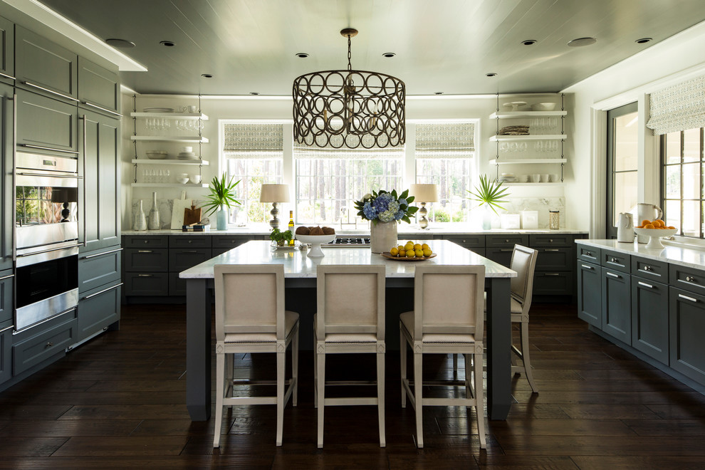 Inspiration for a traditional u-shaped kitchen in Birmingham with shaker cabinets, grey cabinets, white splashback, stainless steel appliances, dark hardwood flooring and an island.