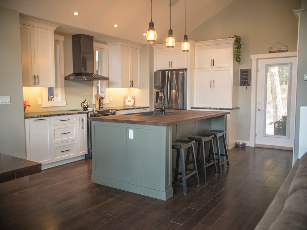 Eat-in kitchen - mid-sized contemporary l-shaped dark wood floor and brown floor eat-in kitchen idea in Calgary with a drop-in sink, shaker cabinets, white cabinets, laminate countertops, stainless steel appliances and an island