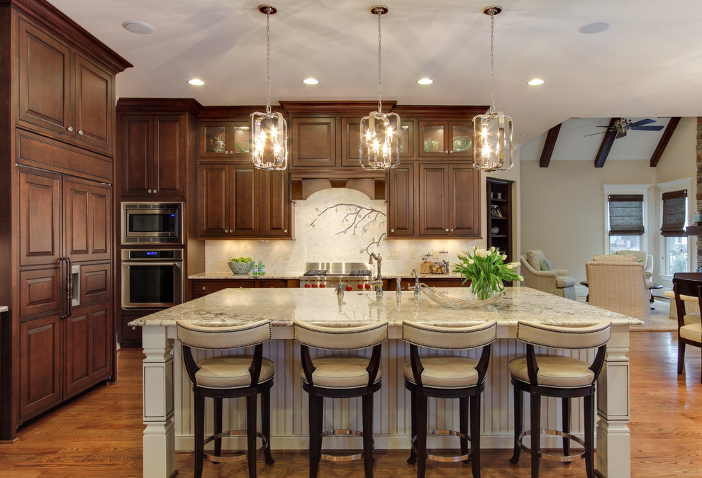 Design ideas for a classic open plan kitchen in Raleigh with raised-panel cabinets, dark wood cabinets, white splashback, medium hardwood flooring and an island.