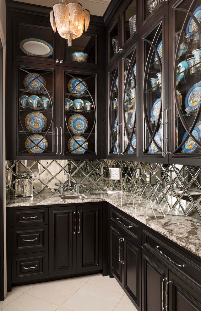 Example of a small transitional l-shaped marble floor enclosed kitchen design in Dallas with an undermount sink, raised-panel cabinets, dark wood cabinets, quartz countertops, metallic backsplash, mirror backsplash and no island