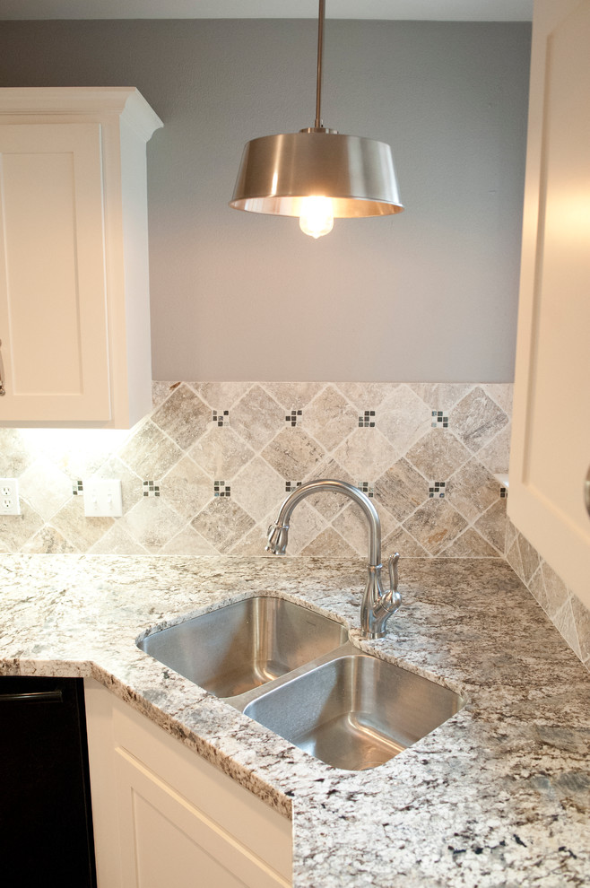 Enclosed kitchen - mid-sized transitional u-shaped porcelain tile enclosed kitchen idea in Houston with an undermount sink, recessed-panel cabinets, white cabinets, granite countertops, gray backsplash, stone tile backsplash and stainless steel appliances