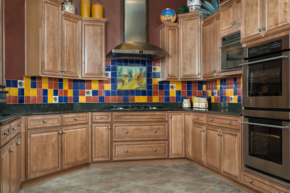 Inspiration for a large mediterranean u-shaped porcelain tile eat-in kitchen remodel in Other with an undermount sink, raised-panel cabinets, light wood cabinets, ceramic backsplash and stainless steel appliances