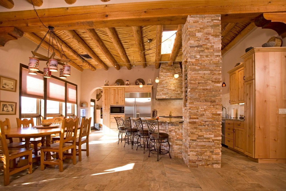 Design ideas for a large rustic l-shaped kitchen/diner in Albuquerque with a submerged sink, raised-panel cabinets, light wood cabinets, granite worktops, beige splashback, ceramic splashback, stainless steel appliances, travertine flooring and an island.