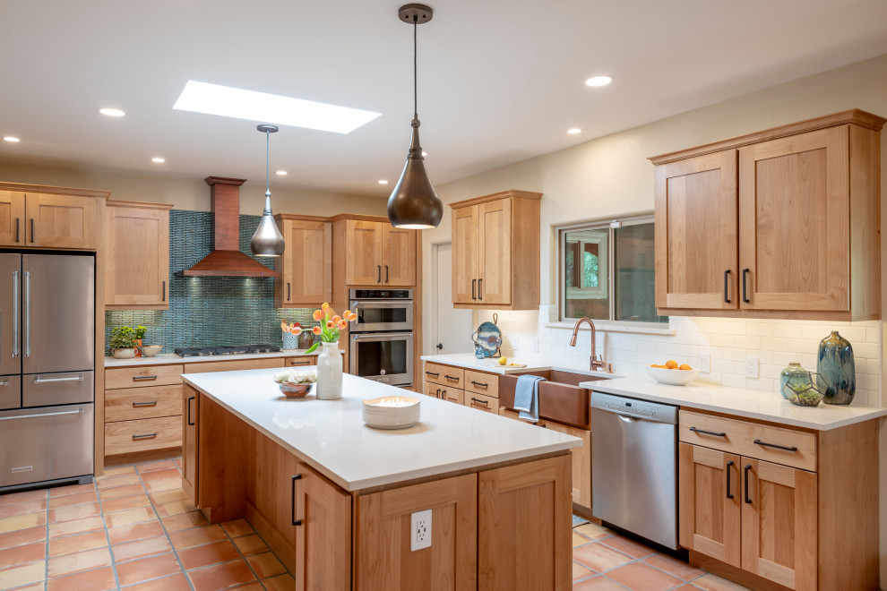 Large southwest terra-cotta tile and orange floor kitchen photo in Other with an undermount sink, shaker cabinets, medium tone wood cabinets, quartz countertops, blue backsplash, ceramic backsplash, stainless steel appliances, an island and white countertops