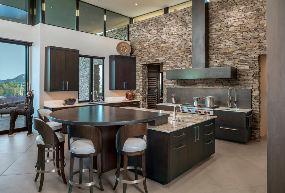 Photo of a large contemporary u-shaped kitchen in Phoenix with a submerged sink, flat-panel cabinets, dark wood cabinets, quartz worktops, black splashback, stainless steel appliances, porcelain flooring, an island, beige floors and beige worktops.
