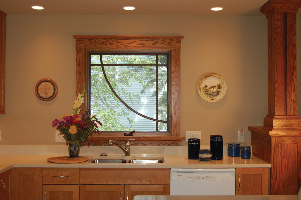 Example of a mid-sized southwest eat-in kitchen design in Other with a double-bowl sink, beaded inset cabinets, light wood cabinets, granite countertops, white appliances, beige backsplash and no island