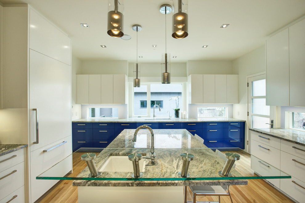 Inspiration for a large contemporary u-shaped light wood floor enclosed kitchen remodel in Calgary with a drop-in sink, flat-panel cabinets, blue cabinets, granite countertops, white appliances and an island
