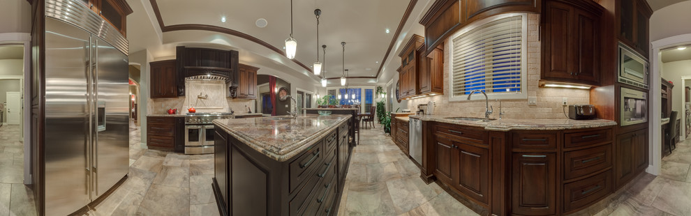 Inspiration for a large timeless galley porcelain tile eat-in kitchen remodel in Calgary with an undermount sink, raised-panel cabinets, granite countertops, beige backsplash, stone tile backsplash, stainless steel appliances and an island