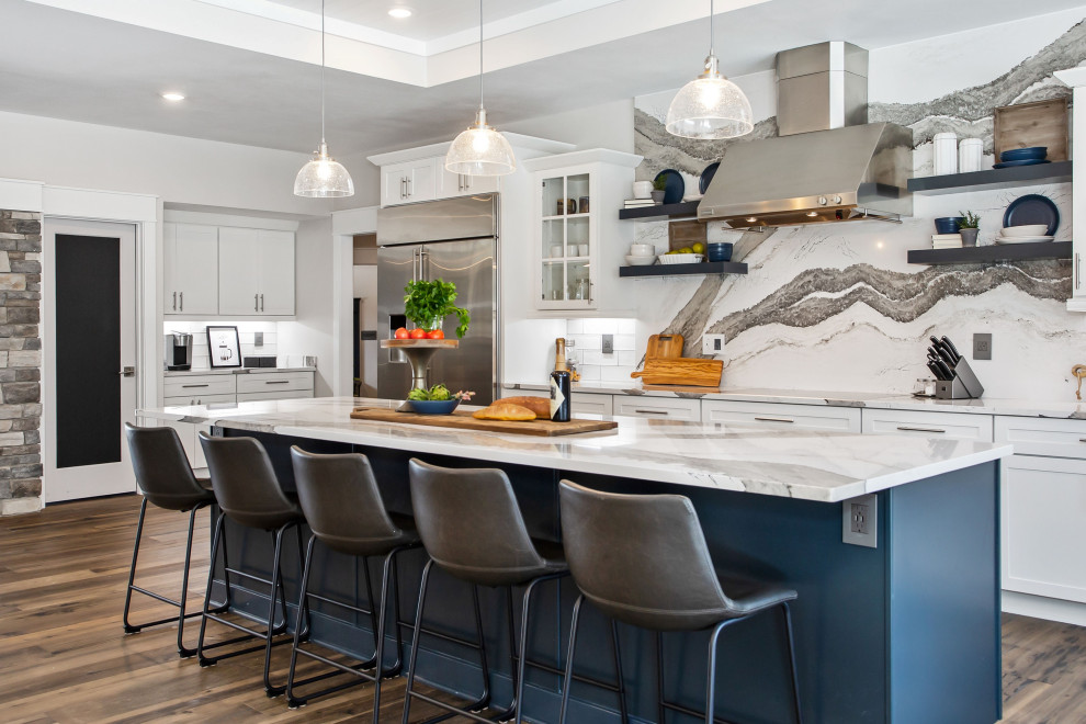 Inspiration for a classic l-shaped kitchen in New York with shaker cabinets, white cabinets, stainless steel appliances, medium hardwood flooring, an island, brown floors, white worktops and a drop ceiling.