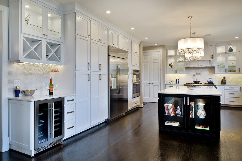 Eat-in kitchen - large modern dark wood floor and brown floor eat-in kitchen idea in DC Metro with a farmhouse sink, white cabinets, quartzite countertops, white backsplash, travertine backsplash, stainless steel appliances, an island and white countertops