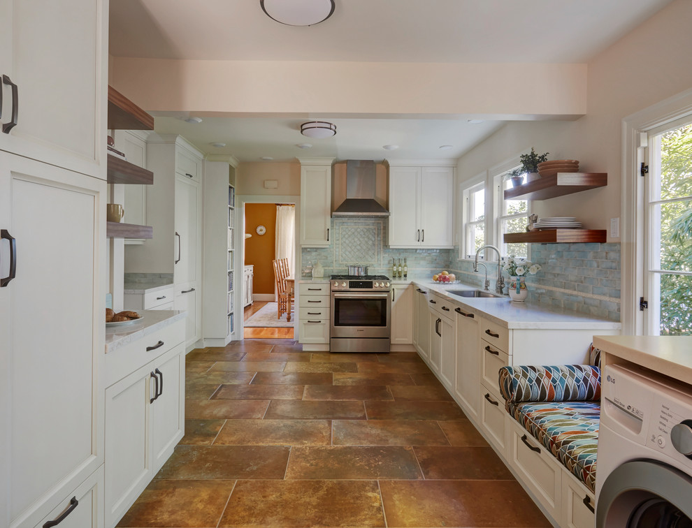 Photo of a medium sized mediterranean galley enclosed kitchen in San Francisco with a submerged sink, recessed-panel cabinets, white cabinets, engineered stone countertops, blue splashback, ceramic splashback, stainless steel appliances, porcelain flooring, no island, brown floors and beige worktops.
