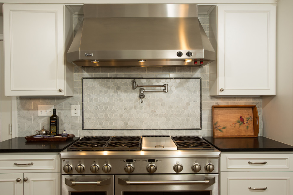 Kitchen photo in DC Metro with stainless steel appliances and an island