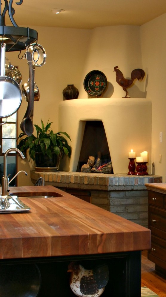 Exempel på ett amerikanskt kök, med en undermonterad diskho, luckor med profilerade fronter, skåp i mörkt trä, träbänkskiva, brunt stänkskydd, stänkskydd i keramik, rostfria vitvaror, mellanmörkt trägolv och en köksö