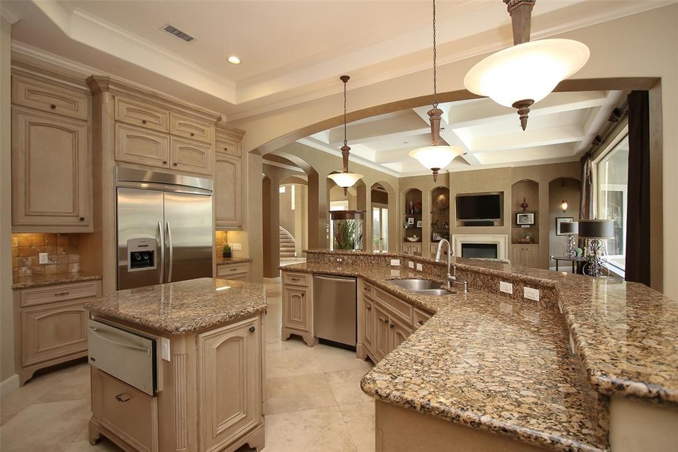 Huge tuscan u-shaped travertine floor and beige floor open concept kitchen photo in Houston with a double-bowl sink, recessed-panel cabinets, light wood cabinets, granite countertops, brown backsplash, terra-cotta backsplash, stainless steel appliances, two islands and beige countertops
