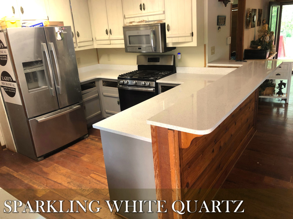 Modern inredning av ett mellanstort vit vitt kök, med bänkskiva i kvartsit, vita skåp, vitt stänkskydd, plywoodgolv, flera köksöar, rött golv, rostfria vitvaror, en dubbel diskho och släta luckor