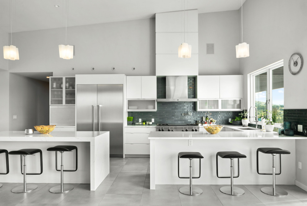 Kitchen - contemporary u-shaped porcelain tile, gray floor and vaulted ceiling kitchen idea in Other with an undermount sink, flat-panel cabinets, white cabinets, quartzite countertops, blue backsplash, subway tile backsplash, stainless steel appliances, two islands and white countertops