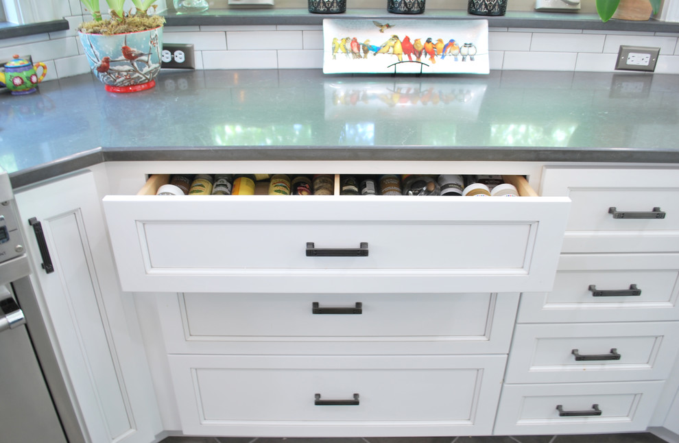 Example of a large transitional ceramic tile eat-in kitchen design in Dallas with a farmhouse sink, recessed-panel cabinets, white cabinets, quartz countertops, white backsplash, ceramic backsplash, stainless steel appliances and an island