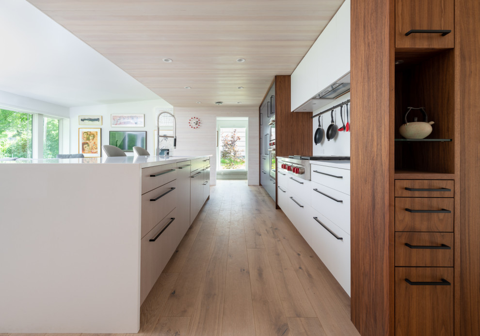 Inspiration for a mid-sized 1950s open concept kitchen remodel in Minneapolis with an undermount sink, flat-panel cabinets, quartz countertops, an island and white countertops